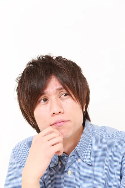 　young Japanese man worries about something — 스톡 사진